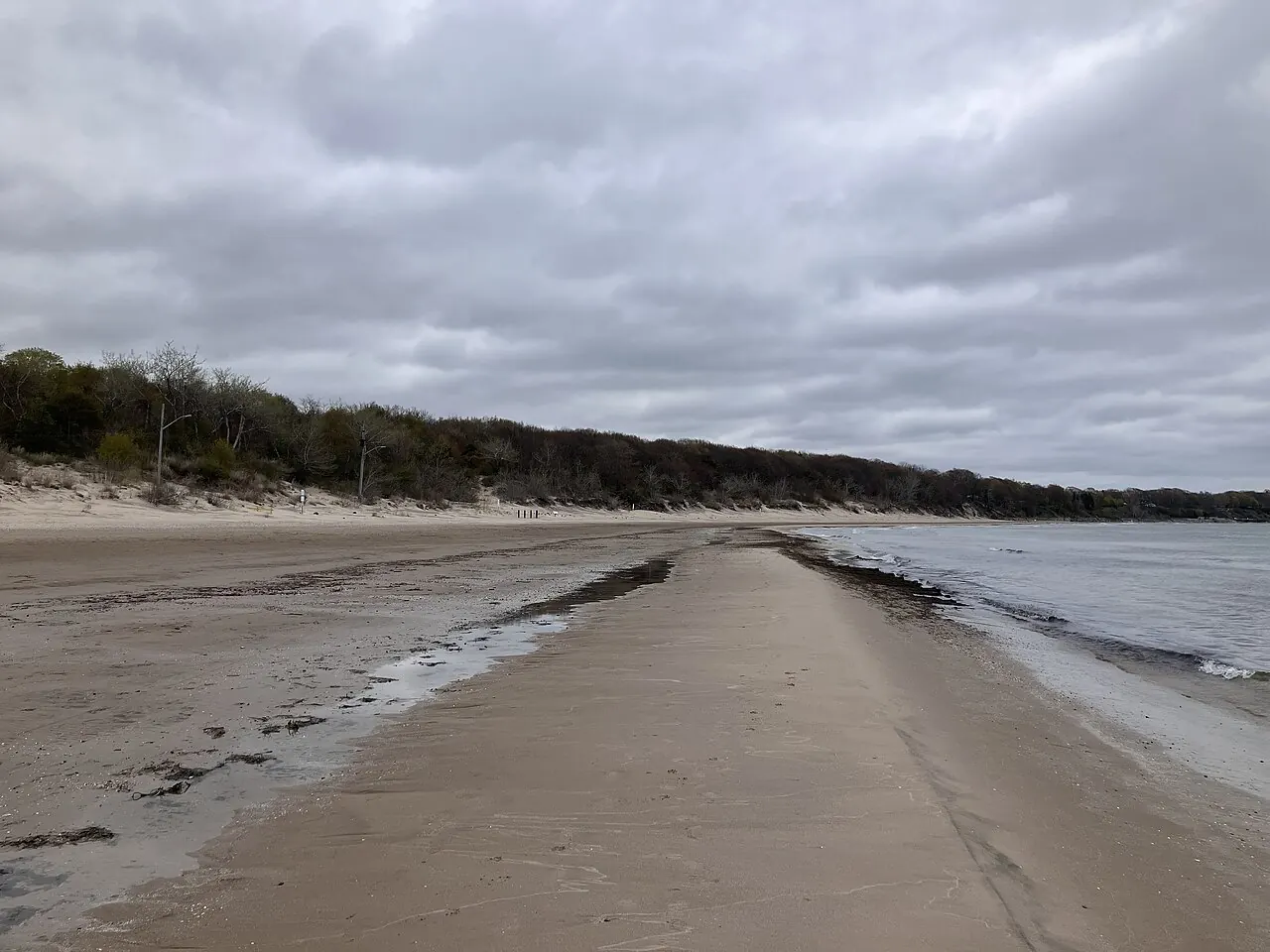 A wide, empty stretch of sand at Nickel Beach on Lake Erie under an overcast sky.